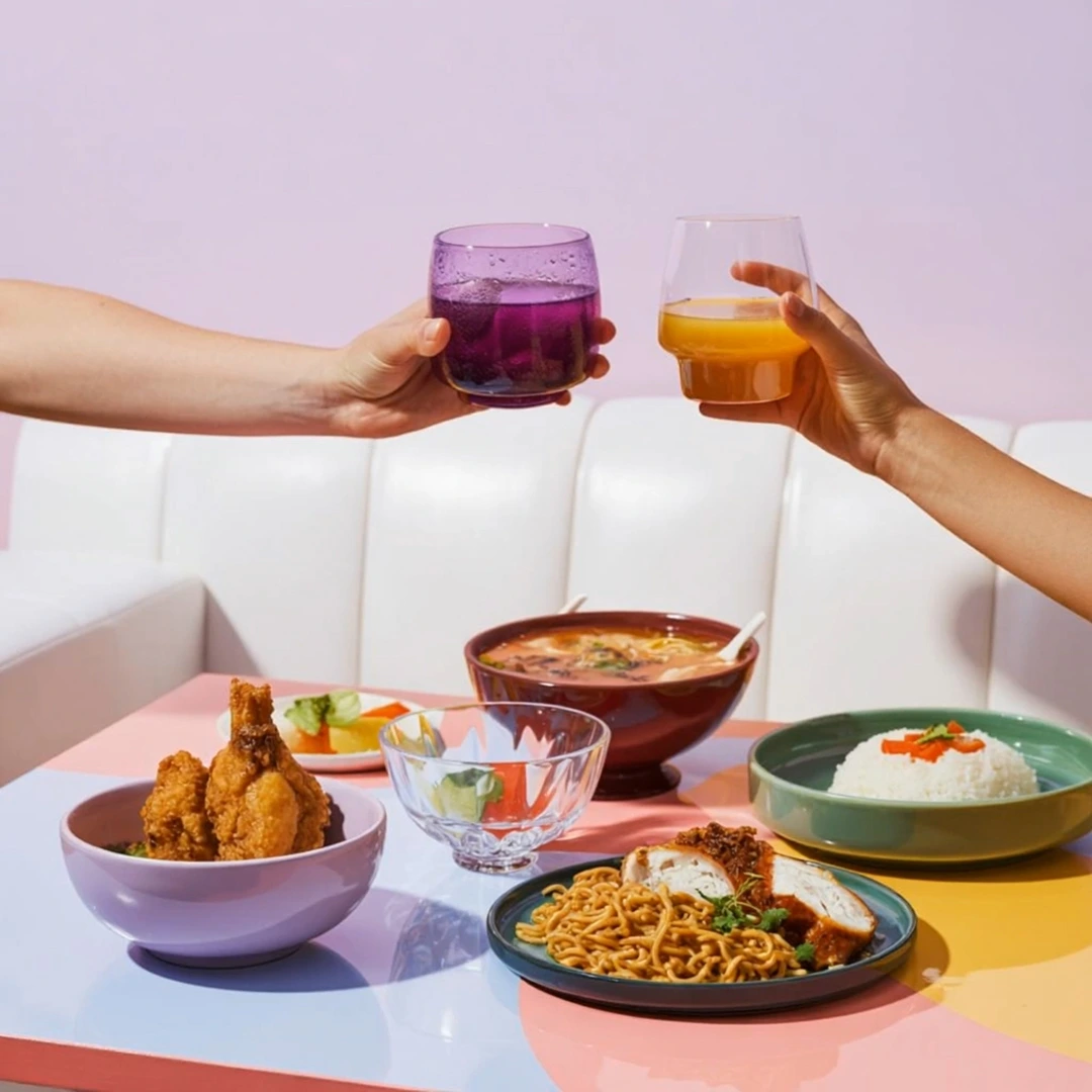 freepik__dynamic-overhead-shot-two-hands-clink-colorful-dri__65427